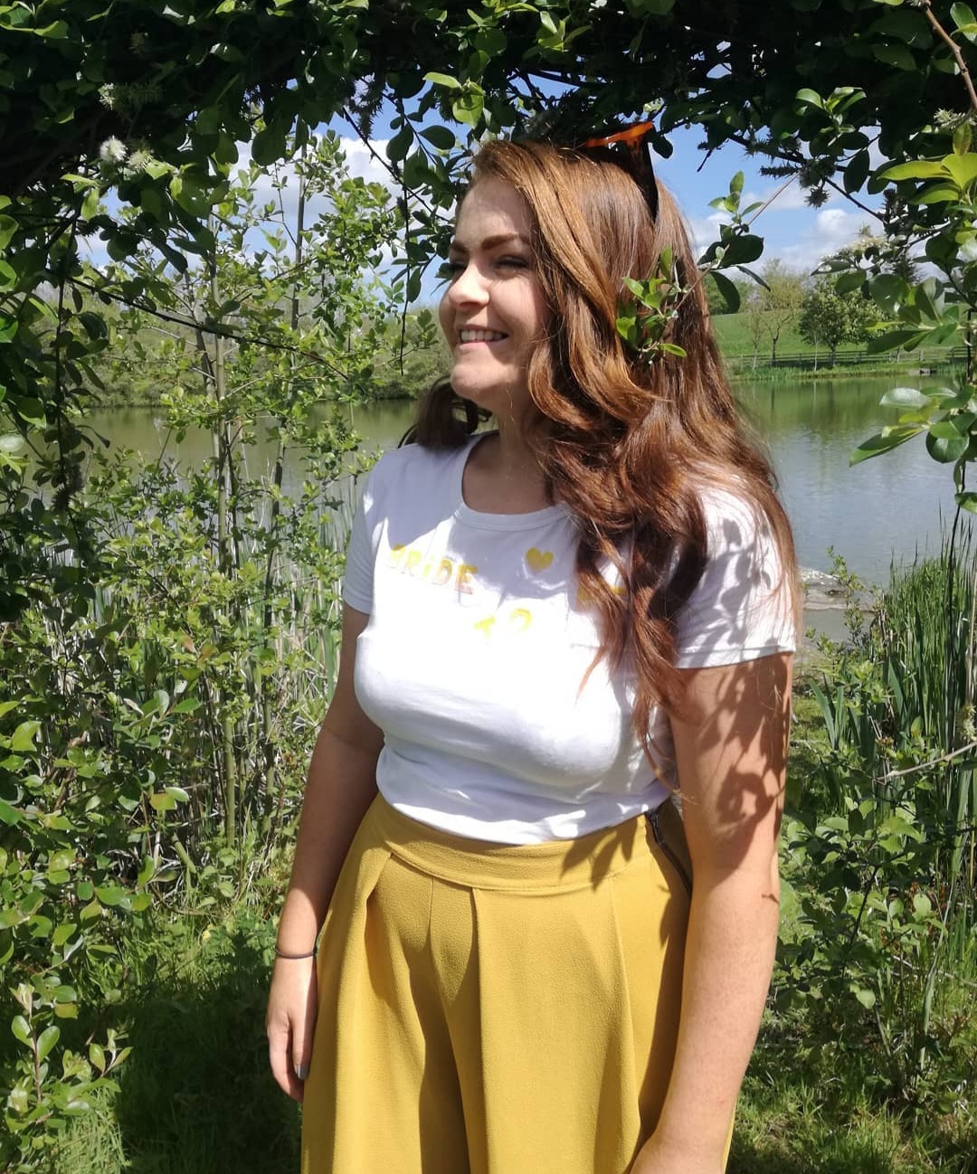 Aimée Ní Riordáin, sean-nós singer and songwriter, standing by a lake in the west of Ireland